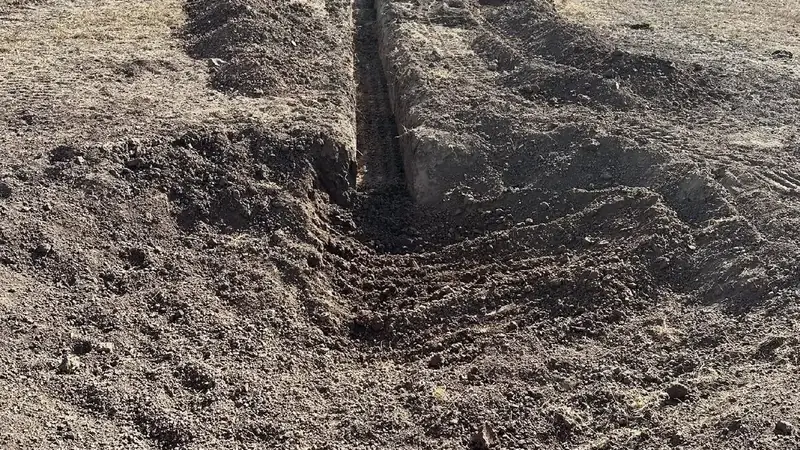 Drainage trench cut across a ranch yard near the livestock pens