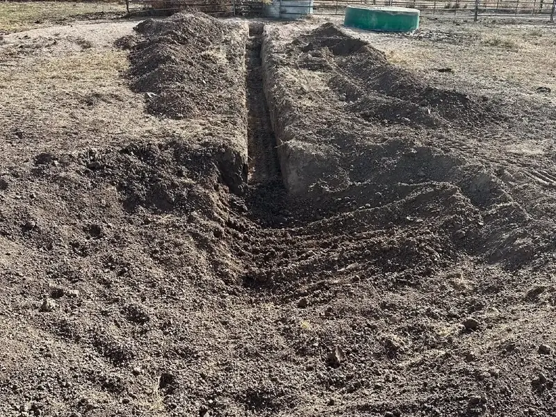 Drainage trench cut across a ranch yard near the livestock pens