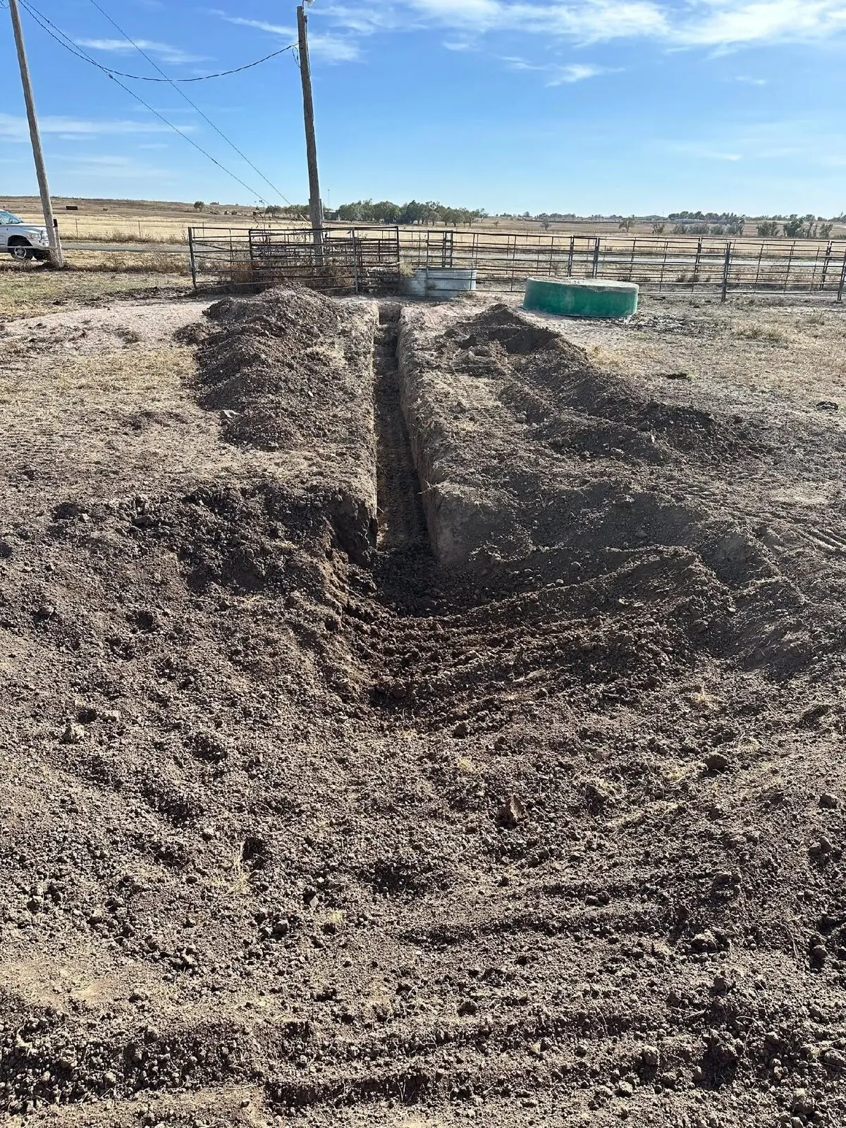 Drainage trench cut across a ranch yard near the livestock pens